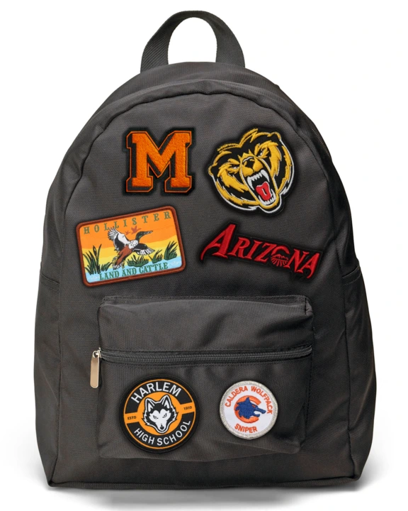 black backpack with custom patches on it